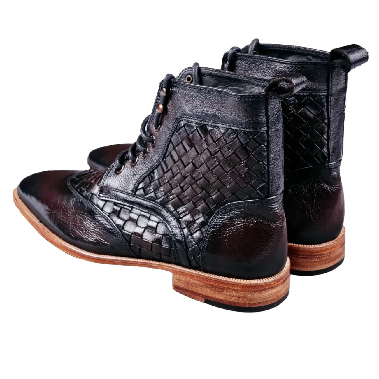 Close-up of brown men's leather ankle boots featuring woven leather sides, smooth toe cap, lace-up design, and wooden sole