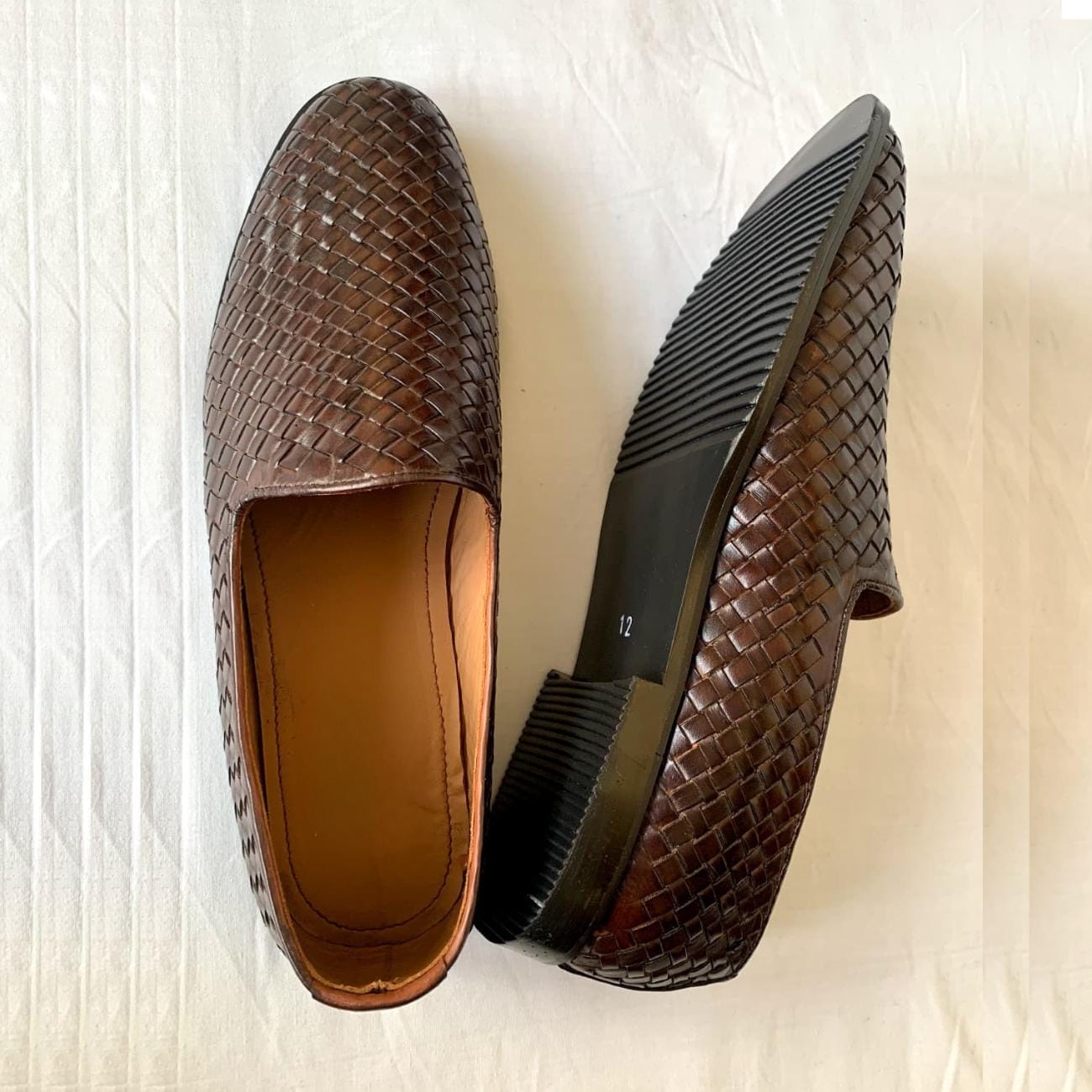 Men's handmade Venetian leather loafers in rich brown with woven leather design, cushioned interior, and durable sole for stylish comfort.