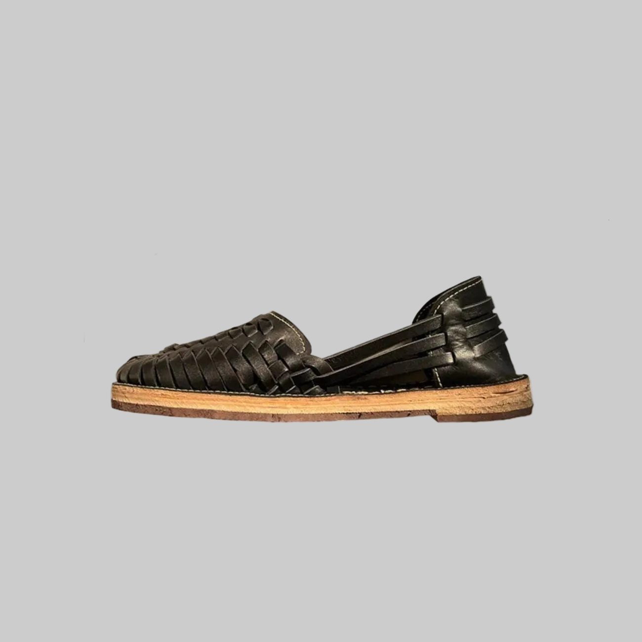 Handmade black leather Mexican Huarache sandal from TAILOR LEATHER featuring woven straps and a traditional design.